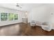 Cozy loft area with two chairs, hardwood floors, bright light, and a ceiling fan at 3760 Oxford Cir, Doraville, GA 30340