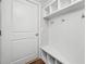 Organized mudroom with built-in bench, hooks, and cubbies for storage at 3760 Oxford Cir, Doraville, GA 30340