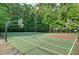 Community basketball court surrounded by lush trees and greenery at 4311 Sentinel Nw Pl, Kennesaw, GA 30144