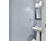 Powder room with a pedestal sink, mirror, and modern lighting at 4311 Sentinel Nw Pl, Kennesaw, GA 30144