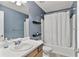 Bathroom featuring a single sink vanity, blue walls, and a shower/tub combo with a white shower curtain at 4311 Sentinel Nw Pl, Kennesaw, GA 30144