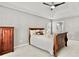 Comfortable bedroom features a tray ceiling, ceiling fan, neutral walls and access to bathroom at 4311 Sentinel Nw Pl, Kennesaw, GA 30144