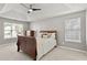 Bright bedroom features a tray ceiling, ceiling fan, neutral walls, and plush carpeting at 4311 Sentinel Nw Pl, Kennesaw, GA 30144