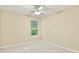Bedroom with a ceiling fan, neutral walls, plush carpeting, and window views at 4311 Sentinel Nw Pl, Kennesaw, GA 30144