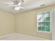 Bright bedroom features a ceiling fan, neutral walls, plush carpeting, and window views at 4311 Sentinel Nw Pl, Kennesaw, GA 30144