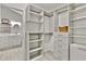 Well-designed walk-in closet flows into the Primary bath and features custom shelving at 4311 Sentinel Nw Pl, Kennesaw, GA 30144