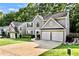 Attractive two-story home featuring gray siding, two-car garage, front yard, and professional landscaping at 4311 Sentinel Nw Pl, Kennesaw, GA 30144