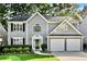 Charming two-story home with gray siding, black shutters, two-car garage and beautifully manicured lawn at 4311 Sentinel Nw Pl, Kennesaw, GA 30144