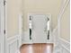 Inviting foyer featuring wood floors, white trim, and a bright front door at 4311 Sentinel Nw Pl, Kennesaw, GA 30144
