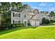 Well-manicured front yard of a two-story home with a two-car garage and driveway at 4311 Sentinel Nw Pl, Kennesaw, GA 30144