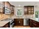 Modern kitchen with stainless steel appliances, granite countertops, and ample cabinet space at 4311 Sentinel Nw Pl, Kennesaw, GA 30144