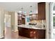Well-equipped kitchen featuring dark wood cabinets, stainless steel appliances, and granite countertops at 4311 Sentinel Nw Pl, Kennesaw, GA 30144