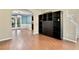 Open living room featuring hardwood floors and an arched entryway to the dining room at 4311 Sentinel Nw Pl, Kennesaw, GA 30144