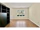 Bright living room with natural light, hardwood floors, and built-in bookcase at 4311 Sentinel Nw Pl, Kennesaw, GA 30144
