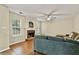 Cozy living room features a brick fireplace, ceiling fan, and hardwood floors at 4311 Sentinel Nw Pl, Kennesaw, GA 30144
