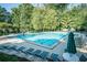 Community pool surrounded by lounge chairs and greenery at 4311 Sentinel Nw Pl, Kennesaw, GA 30144