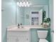 Bright bathroom with a sink, toilet, and a large mirror with vanity lights at 4330 Volnay Ne Ct, Marietta, GA 30066