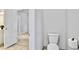 Clean bathroom with a toilet and open door leading to a carpeted room at 4330 Volnay Ne Ct, Marietta, GA 30066