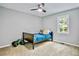 Cozy bedroom featuring a bed with a blue blanket and a ceiling fan at 4330 Volnay Ne Ct, Marietta, GA 30066