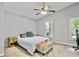 Cozy bedroom featuring a ceiling fan, plush carpet, and tree views at 4330 Volnay Ne Ct, Marietta, GA 30066