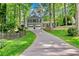 Traditional home with a long driveway, two-car garage, covered front porch, and mature trees at 4330 Volnay Ne Ct, Marietta, GA 30066