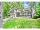 Beautiful home exterior with lush green lawn, covered porch with seating, and two car garage at 4330 Volnay Ne Ct, Marietta, GA 30066