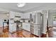 Well-lit kitchen featuring stainless steel appliances, white cabinets, and hardwood flooring at 4330 Volnay Ne Ct, Marietta, GA 30066