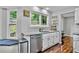 Modern kitchen boasts white cabinets, granite countertops, stainless steel appliances, and window nook at 4330 Volnay Ne Ct, Marietta, GA 30066