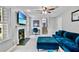 Cozy living room featuring a fireplace, blue sofa, and an adjacent office area at 4330 Volnay Ne Ct, Marietta, GA 30066