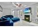 Comfortable living room with a blue sofa, fireplace, and large TV at 4330 Volnay Ne Ct, Marietta, GA 30066