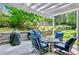 Comfortable outdoor patio area with seating, a grill, and serene views of the landscaped backyard at 4330 Volnay Ne Ct, Marietta, GA 30066