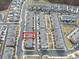 Aerial view of a grey townhome with a red box surrounding it, surrounded by similar townhomes at 1309 Bennett Creek Ovlk, Suwanee, GA 30024