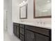 Modern bathroom featuring double sinks, and dark wood cabinets at 1309 Bennett Creek Ovlk, Suwanee, GA 30024