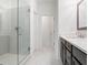 Bathroom featuring a glass enclosed shower, white walls, and a vanity with a large mirror at 1309 Bennett Creek Ovlk, Suwanee, GA 30024