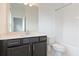 Bathroom featuring a single vanity with a dark wood cabinet, a large mirror, and a shower with white tile at 1309 Bennett Creek Ovlk, Suwanee, GA 30024