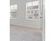Bright bedroom featuring neutral carpet, white walls, and two windows with neighborhood views at 1309 Bennett Creek Ovlk, Suwanee, GA 30024