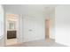 Bedroom with light-colored carpet, white walls, and easy access to a bathroom and closet at 1309 Bennett Creek Ovlk, Suwanee, GA 30024
