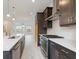 Contemporary kitchen with stainless steel appliances, dark cabinets, and a large island at 1309 Bennett Creek Ovlk, Suwanee, GA 30024