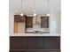 Modern kitchen with center island, stainless steel appliances, white subway tile backsplash, and dark cabinets at 1309 Bennett Creek Ovlk, Suwanee, GA 30024
