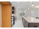 Gourmet kitchen featuring stainless steel appliances, quartz countertops, and a center island with sink at 1309 Bennett Creek Ovlk, Suwanee, GA 30024
