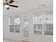 Bright living room featuring large windows that let in natural light and a ceiling fan for added comfort at 1309 Bennett Creek Ovlk, Suwanee, GA 30024