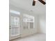Bright living room featuring large windows that let in natural light and a ceiling fan for added comfort at 1309 Bennett Creek Ovlk, Suwanee, GA 30024