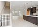 Open-concept living space featuring hardwood floors, staircase, and kitchen with a center island at 1309 Bennett Creek Ovlk, Suwanee, GA 30024