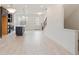 Open-concept living space showcasing kitchen island, wood floors, and staircase leading to the upper level at 1309 Bennett Creek Ovlk, Suwanee, GA 30024