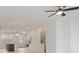 Bright living space with wood floors, kitchen island, ceiling fan, and staircase to the second level at 1309 Bennett Creek Ovlk, Suwanee, GA 30024