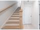 A bright staircase features natural wood treads, handrail, and banister at 1309 Bennett Creek Ovlk, Suwanee, GA 30024