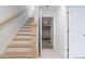 A bright staircase leads to the garage entrance, featuring natural wood treads and a banister at 1309 Bennett Creek Ovlk, Suwanee, GA 30024