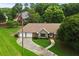 Aerial view of a well-maintained home with a two-car garage, stone accents, and an expansive, beautifully landscaped yard at 2139 Bramlett Nw Pl, Marietta, GA 30064