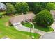 Overhead view showcasing a lovely brick home with a two-car garage, lush landscaping, and a pristine, green lawn at 2139 Bramlett Nw Pl, Marietta, GA 30064