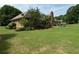 Expansive backyard featuring lush green grass, mature trees, and a cozy deck area for outdoor enjoyment at 2139 Bramlett Nw Pl, Marietta, GA 30064